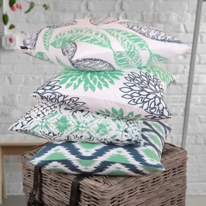 Decorative throw pillow covers set with botanical leaf and abstract geometric floral prints.