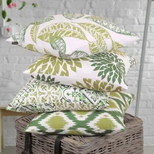 Green printed pillowcase detail featuring botanical and geometric patterns on a stacked display.
