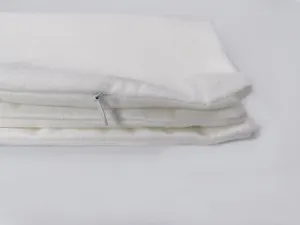 Detailed close-up view of white cushion cover, soft fabric texture with hidden zipper.