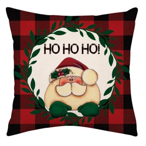Funda de cojín navideña con cuadros rojos y negros, lindo Papá Noel y texto festivo.