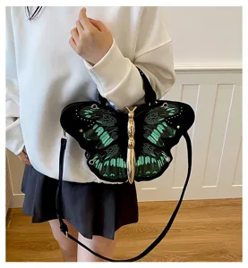 Chic butterfly shaped shoulder bag with black green wings and gold metallic body accent.