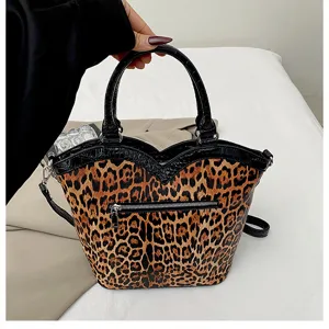 Leopard print handbag with black faux leather trim, chic Y2K commuter shoulder bag detail.