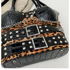 Detail shot of Y2K punk style handbag featuring leopard print, black texture, and metal chains.