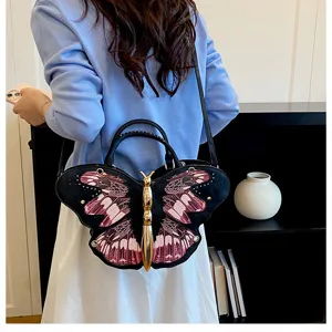 Trendy butterfly shaped shoulder bag detail, chic niche design handbag with golden metallic body.