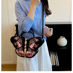 Detailed view of the unique butterfly-shaped handbag featuring an exquisite metal body and wings.