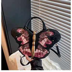 Detailed showcase of unique butterfly shaped shoulder bag with chic wings and gold hardware.