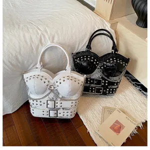 Detail view of punk style Y2K shoulder handbag with corset design, studs, and chains.
