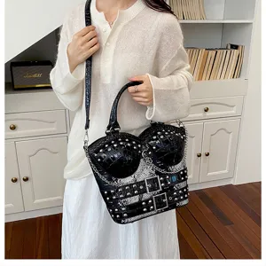 Y2K punk style black faux leather shoulder handbag with studs, chains and snake print.