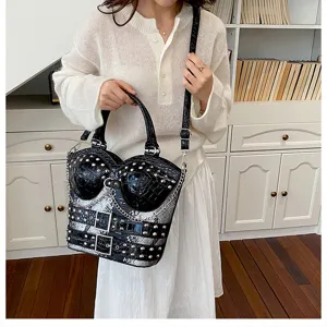 Detail view of stylish Y2K gothic handbag with corset design, studs, and python texture.