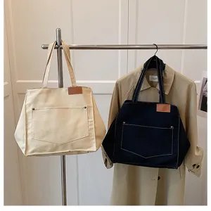 Casual canvas tote bag for women, large capacity shoulder handbag with front pocket.