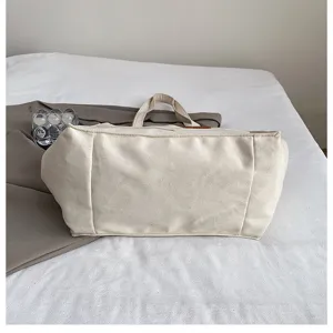 Detailed view of casual canvas tote bag showing bottom structure and quality fabric material.