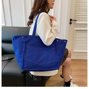 Large capacity blue canvas tote bag for women, simple casual shoulder handbag with front pocket.