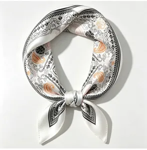 Detailed shot of a 100% mulberry silk small square scarf with elegant paisley print.
