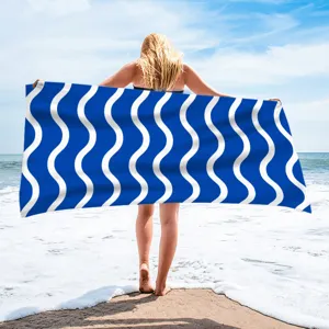 Detailed view of the blue and white wave printed quick-drying polyester beach towel.