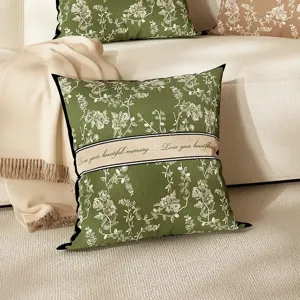 Luxury green floral linen throw pillow with decorative English text band for cozy living room sofa.