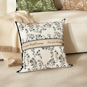 Detailed view of floral print throw pillow with elegant botanical pattern and text band for sofa.