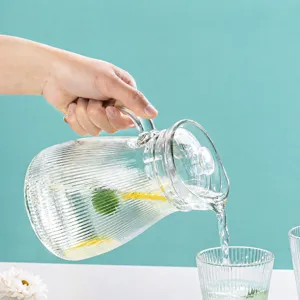 Glass water pitcher set, clear ribbed glass jug and cups for modern home and guests.