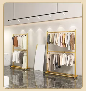 Double tier gold clothing rack detail showing sturdy metal poles and smooth rolling caster wheels.