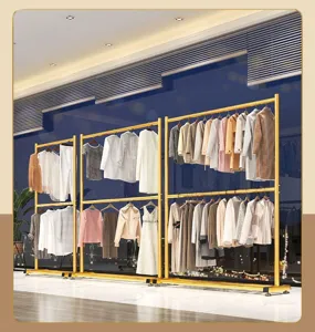 Detail shot of the golden double tier clothes rack displaying neat indoor garment hanging setup.