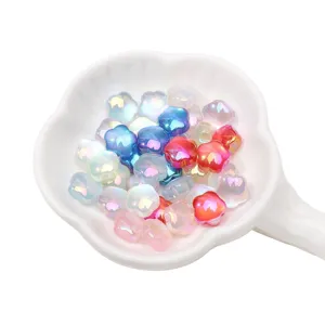 Close-up detail of colorful iridescent acrylic flower beads for handmade DIY jewelry crafting.