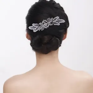 Detailed close-up of a silver butterfly hair comb with pearls and rhinestones for buns.