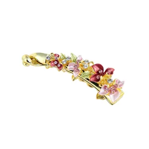 Gold-tone alloy banana hair clip featuring colorful painted enamel flowers and sparkling rhinestones.