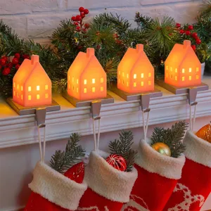 Christmas glowing house stocking holders set, warm LED light mantel decor for holiday party.