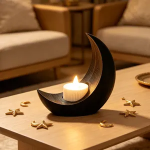 Primer plano detalle del portavelas luna negra con vela LED calida y decoracion de estrella dorada.