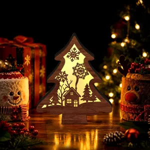 LED wooden Christmas tree night light closeup, hollow carved holiday desktop decor ornament.