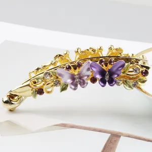 Gold alloy banana hair clip featuring purple enamel butterflies and sparkling rhinestones.