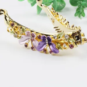 Gold metal banana hair clip with purple enamel flowers and sparkling rhinestones for women.