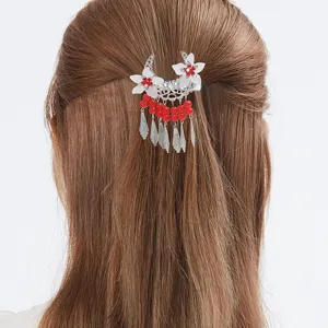 Traditional ethnic style hair clip featuring cute white flowers, red beads, and lovely tassels.