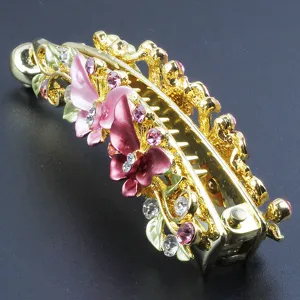 Close-up view of a gold-tone alloy hair banana clip featuring rhinestone butterflies and leaves.