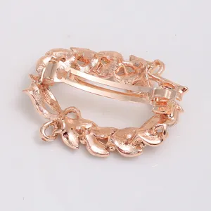Rose gold hair clip with elegant leaf wreath design, displaying the back spring clasp mechanism.
