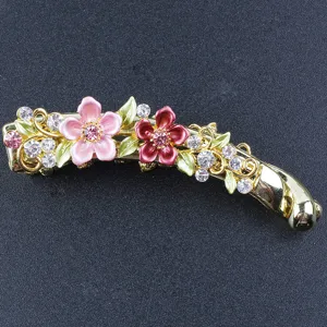 Close-up of elegant floral banana hair clip with rhinestones and colorful enamel design.