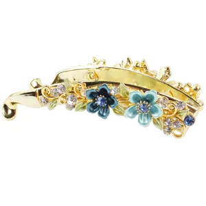 Gold alloy banana hair clip with blue enamel flowers and sparkling crystal rhinestones.