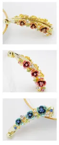 Detail of alloy banana hair clip with enamel floral accents and sparkling crystal rhinestones.