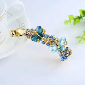Elegant crystal butterfly banana hair clip with blue rhinestones and alloy for women and girls daily wear.