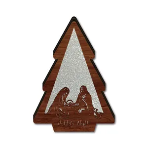 Close-up detail of wooden Christmas tree decoration with nativity scene and sparkle background.