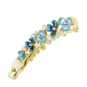 Gold metal banana hair clip featuring blue enamel flowers and sparkling rhinestones for women.