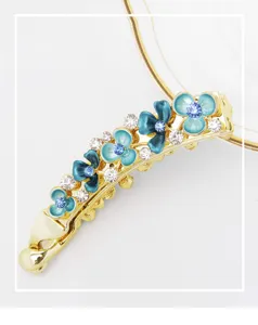 Detailed view of the enamel flower banana hair clip with sparkling rhinestones for women.