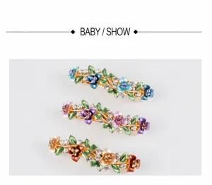 Detailed view of elegant floral rhinestone spring hair clip with colorful enamel leaves.