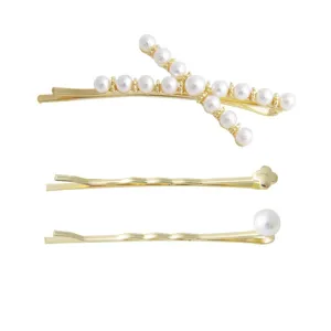 Gold hair clip set featuring pearl cross hairpins and elegant wavy metal designs for women.