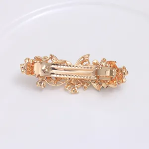 Vintage gold alloy hair clip with floral and butterfly design, elegant retro spring barrette.