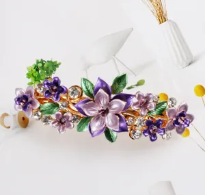 Exquisite purple enameled flower hair clip with sparkling rhinestones and metal spring base.
