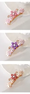 Detail view of alloy hair clip with flower and pearl embellishments in multiple colors.