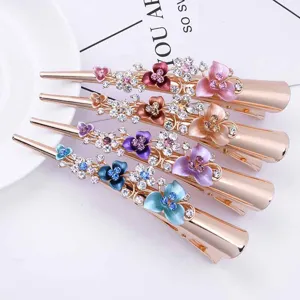 Close-up detail of elegant metal rhinestone hair clips with colorful flower designs.