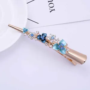 Detail shot of Korean style gold alloy hair clip with blue enamel flowers and sparkling rhinestones.