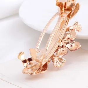 Elegant gold metal hair barrette spring clip for women, chic floral design hair accessory.