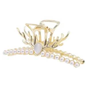 Elegant gold hair claw clip featuring faux pearls and unique branch design for women.